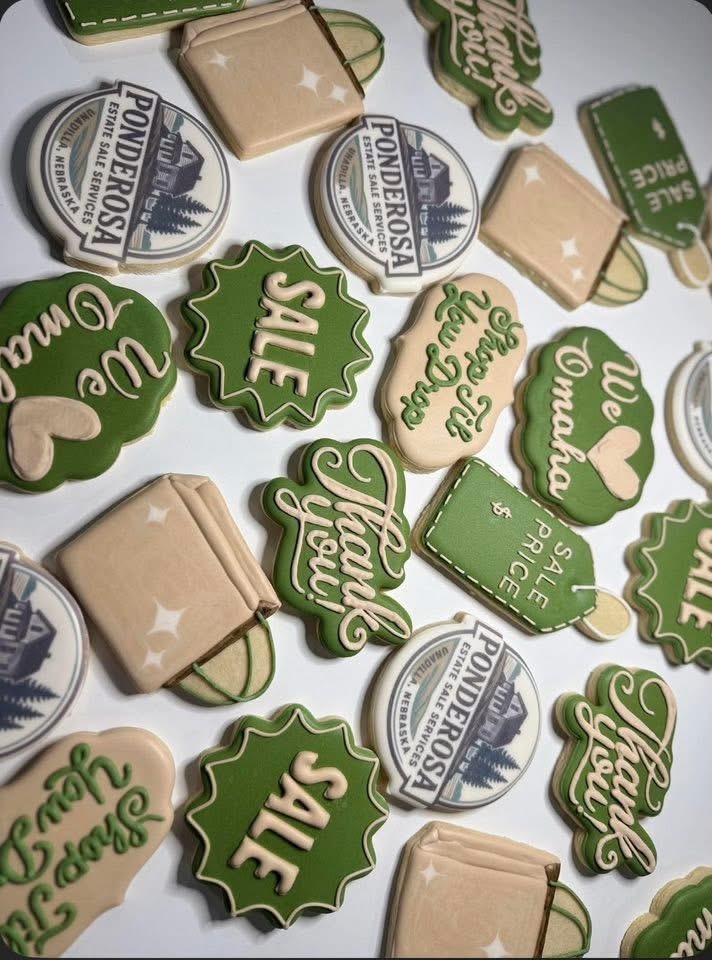 Decorative cookies in various shapes featuring phrases like "Thank You" and "Sale," showcasing a themed design for a promotional event.